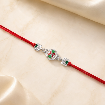 Top view of silver pinwheel flower rakhi with thread
