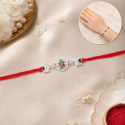 Silver Pinwheel Flower Rakhi with dori on white background