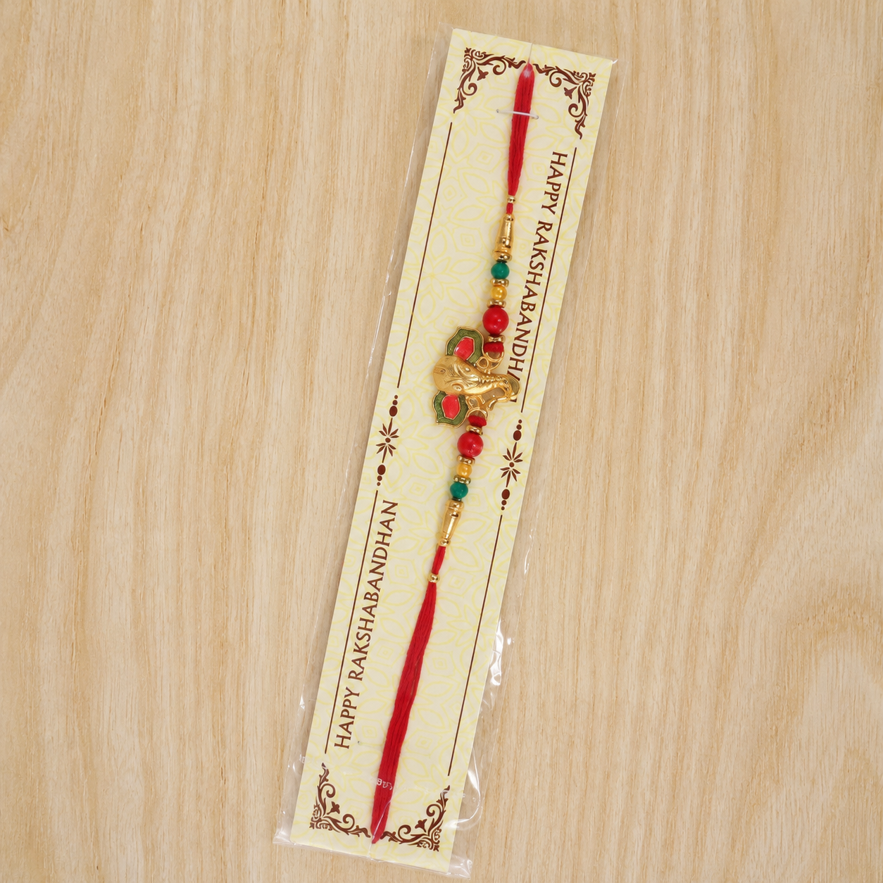 Full rakhi with golden Ganesha charm and vibrant beads