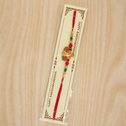 Full rakhi with golden Ganesha charm and vibrant beads