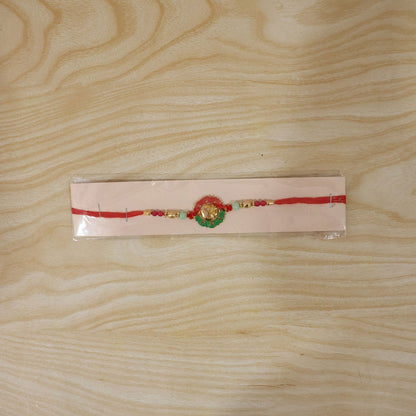 Traditional Golden Om Rakhi with elegant beads