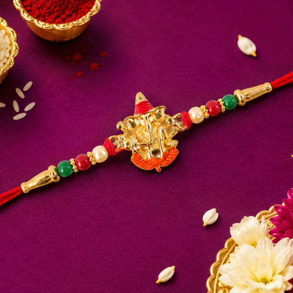 Ganesha Meenakari Rakhi displayed on a festive background, perfect for gifting.