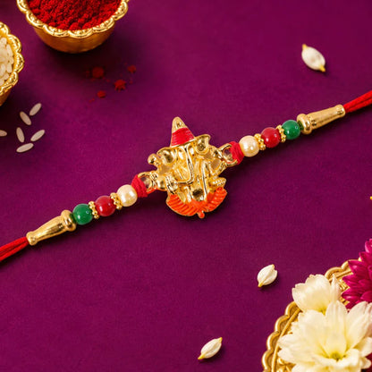 Ganesha Meenakari Rakhi displayed on a festive background, perfect for gifting.