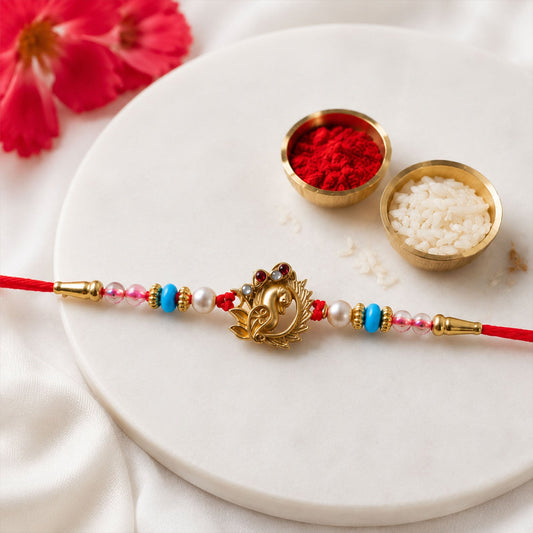 Beautiful decorative rakhi with turquoise pearls and traditional design