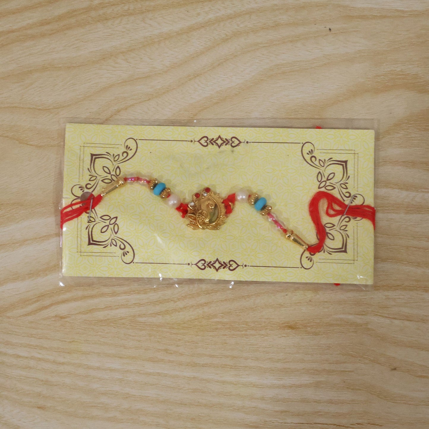 Golden Peacock Rakhi with Turquoise & Pearls