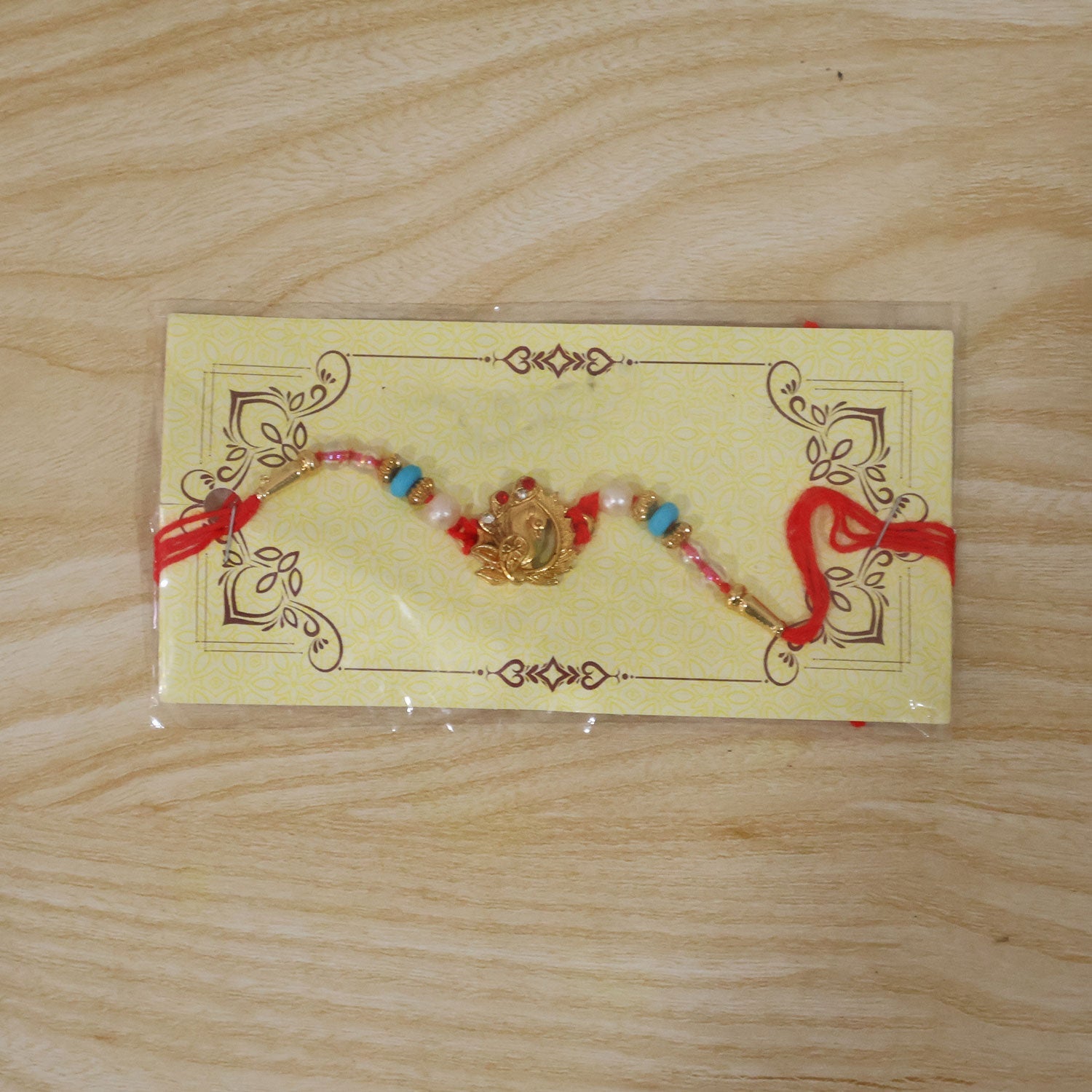 Golden Peacock Rakhi with Turquoise & Pearls