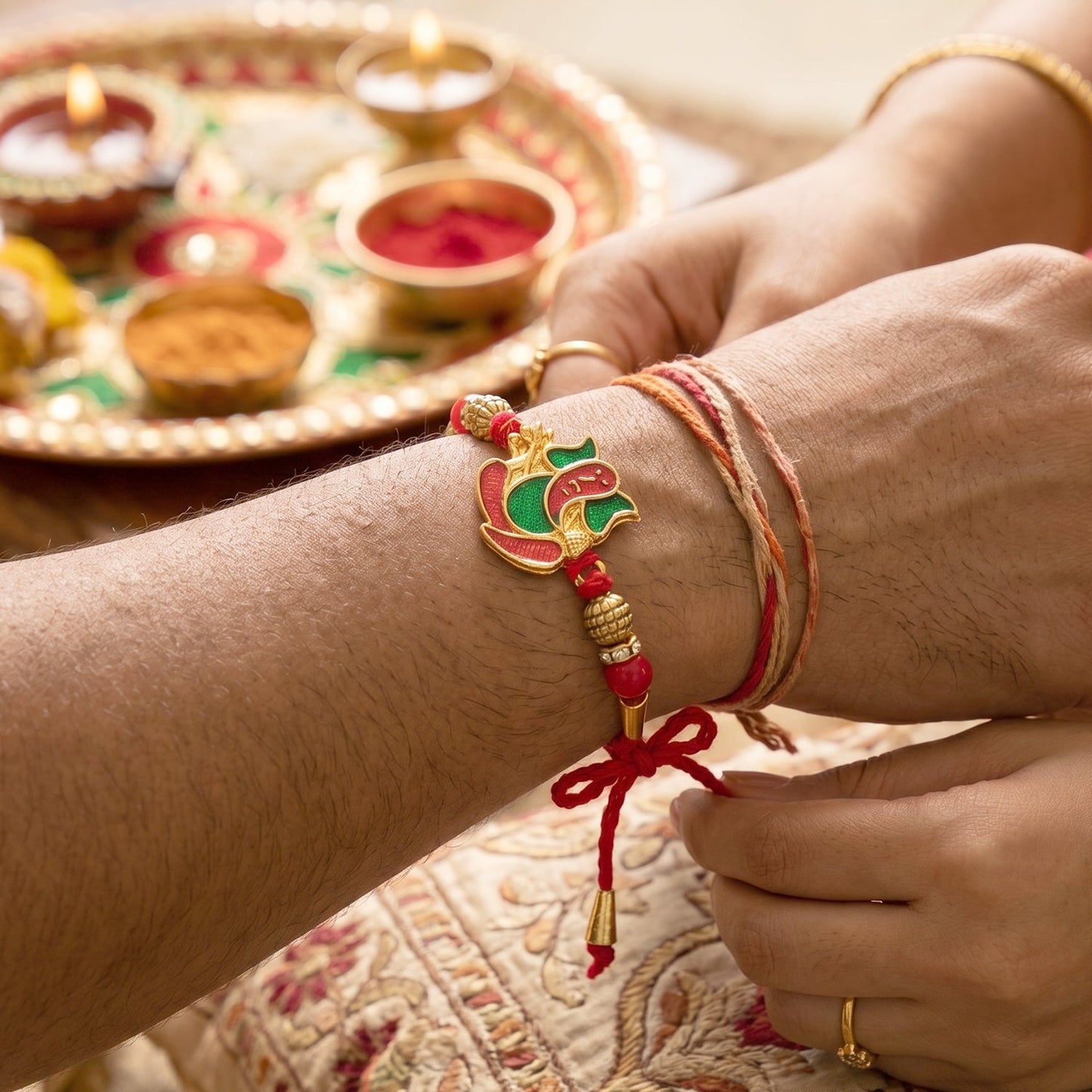 Lord Ganesha Meenakari Rakhi in Red & Green