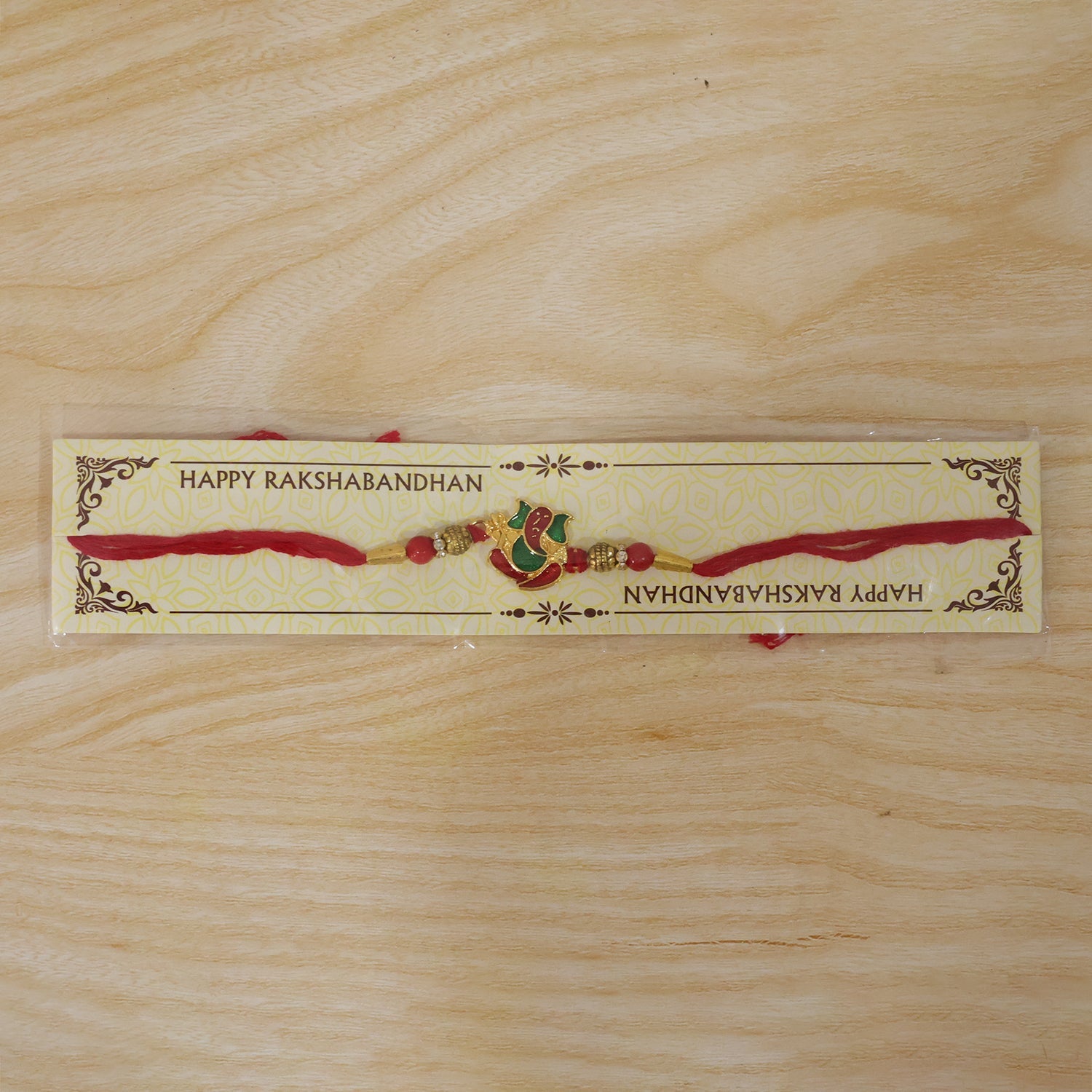 Lord Ganesha Meenakari Rakhi in Red & Green