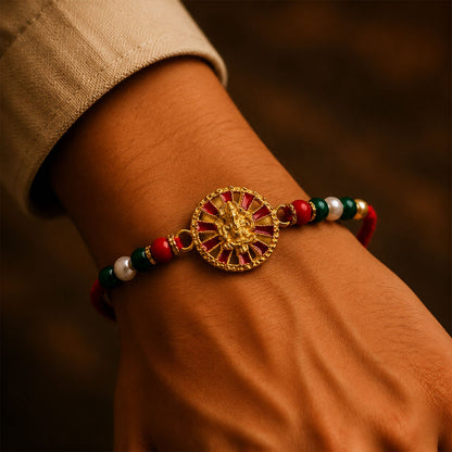 Golden Ganesha Wheel Rakhi with Red Enamel