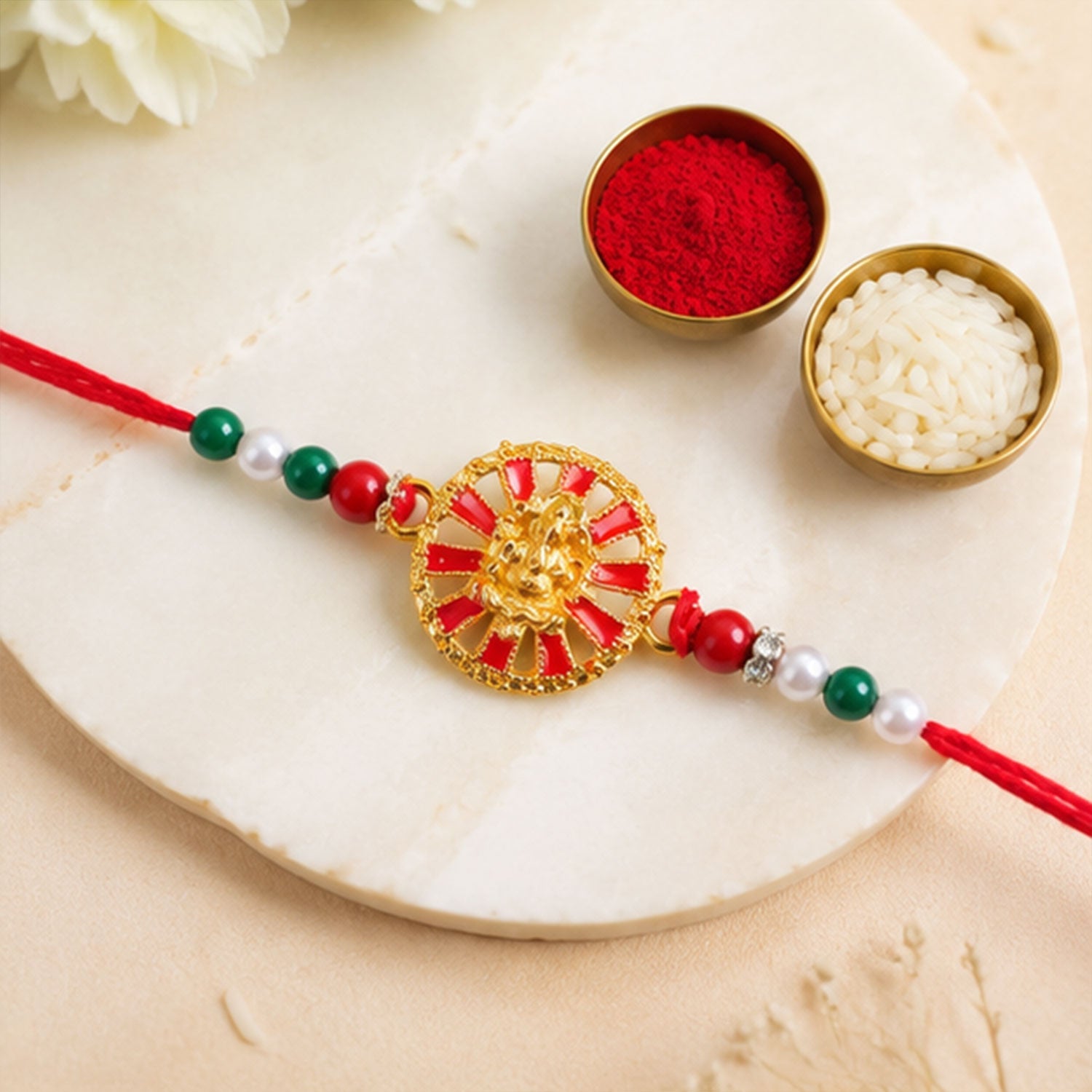 Golden Ganesha Wheel Rakhi with Red Enamel