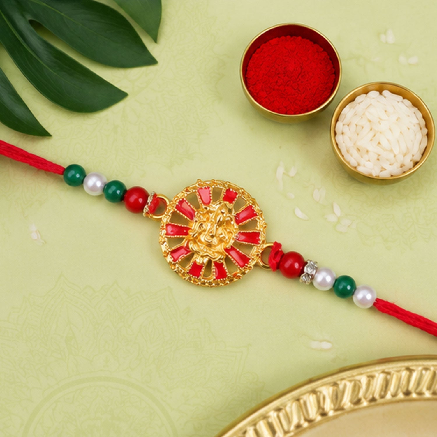 Golden Ganesha Wheel Rakhi with Red Enamel