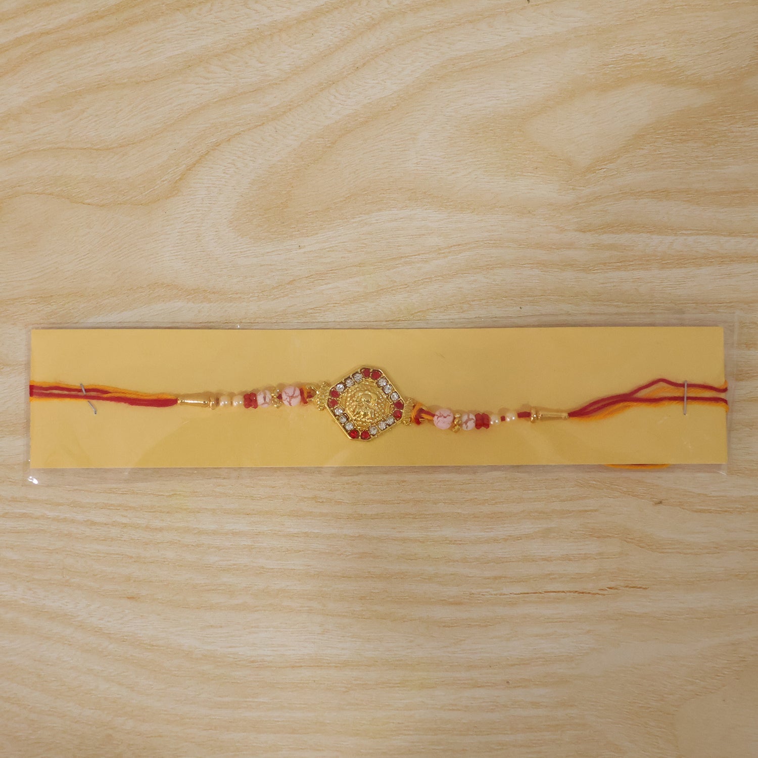 Goddess Lakshmi Rakhi with Red & White Stones