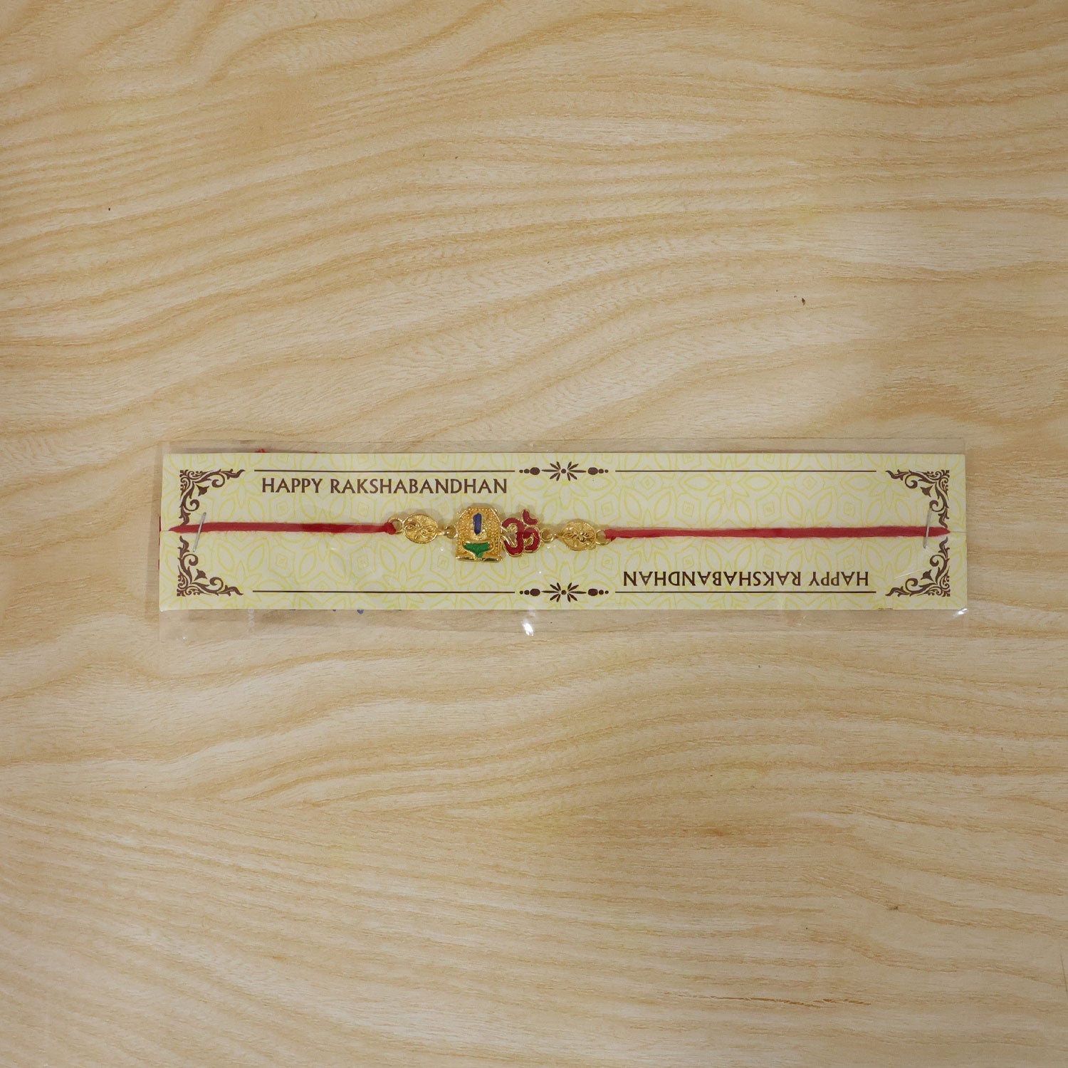 Golden 'Om' Rakhi with Blue Stone & Leaf