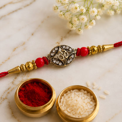 Antique Golden 'Om' Oval Rakhi