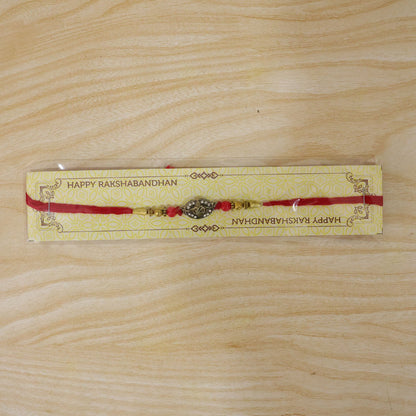 Antique Golden 'Om' Oval Rakhi