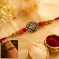 Antique Golden Om Oval Rakhi – Elegant Traditional Design for Raksha Bandhan