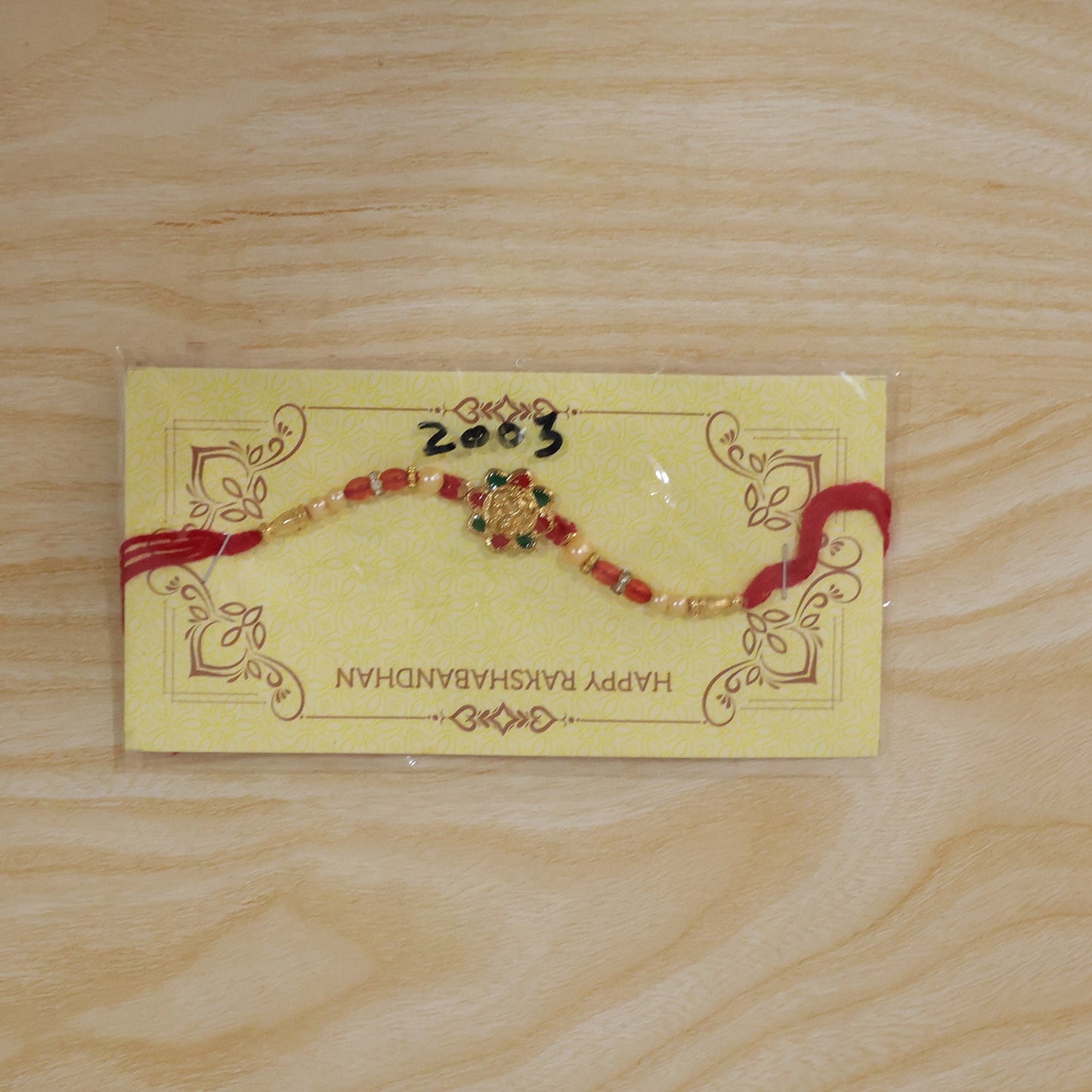 Traditional Golden Floral Meenakari Rakhi with Pearls & Red Beads for Brother - Rakshabandhan Gift