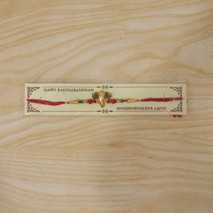 Lord Ganesha Golden Meenakari Rakhi with Red & Green Beads for Brother