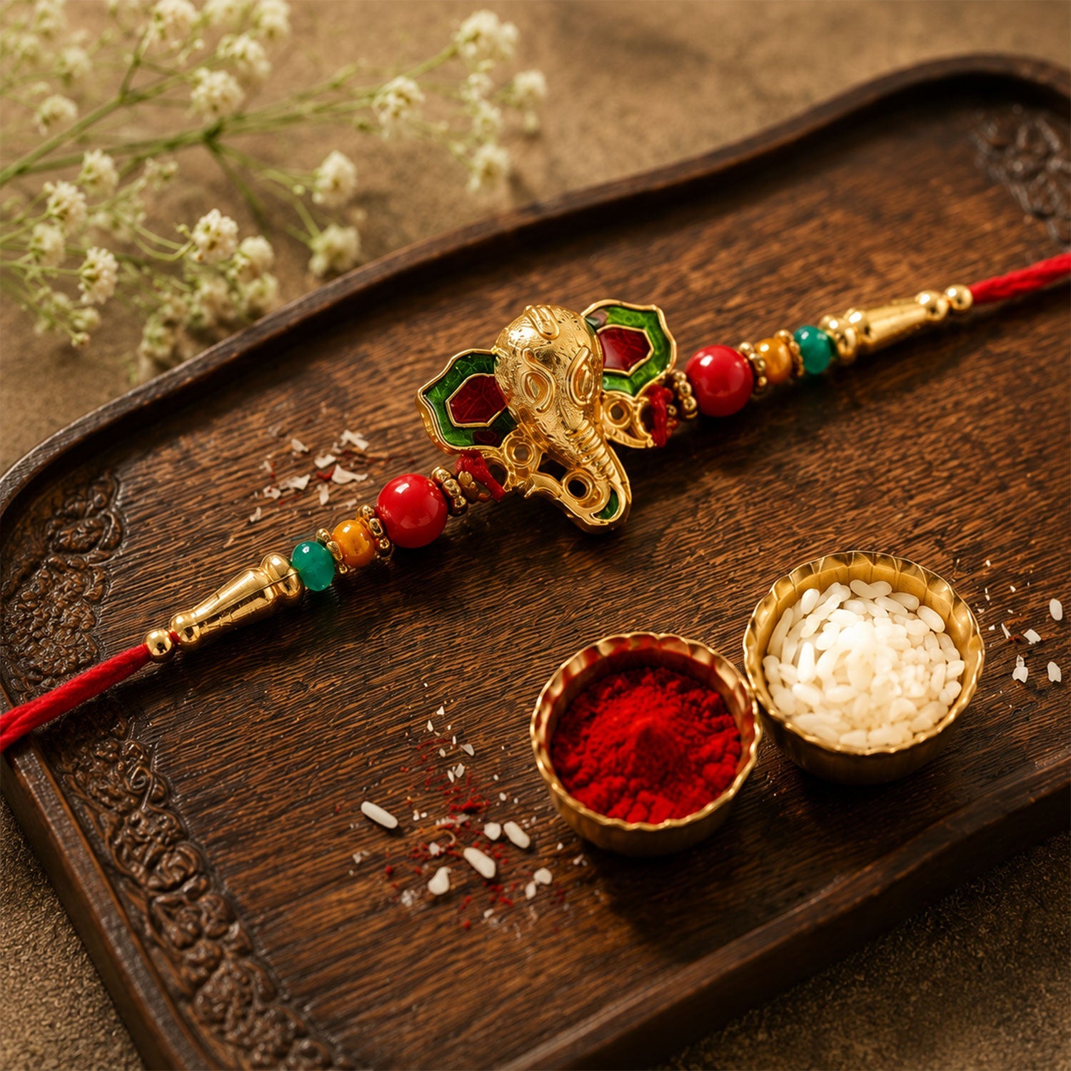 Lord Ganesha Golden Meenakari Rakhi with Red & Green Beads for Brother
