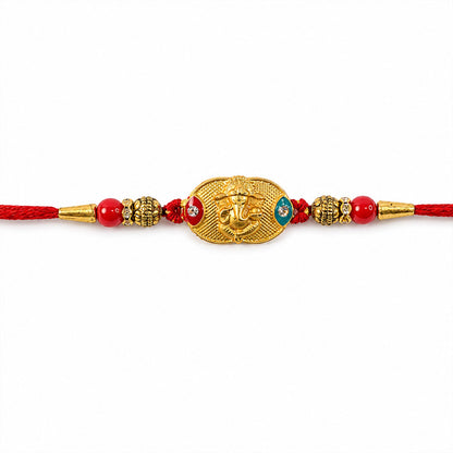 Festive Lord Ganesha rakhi displayed flat with red beads