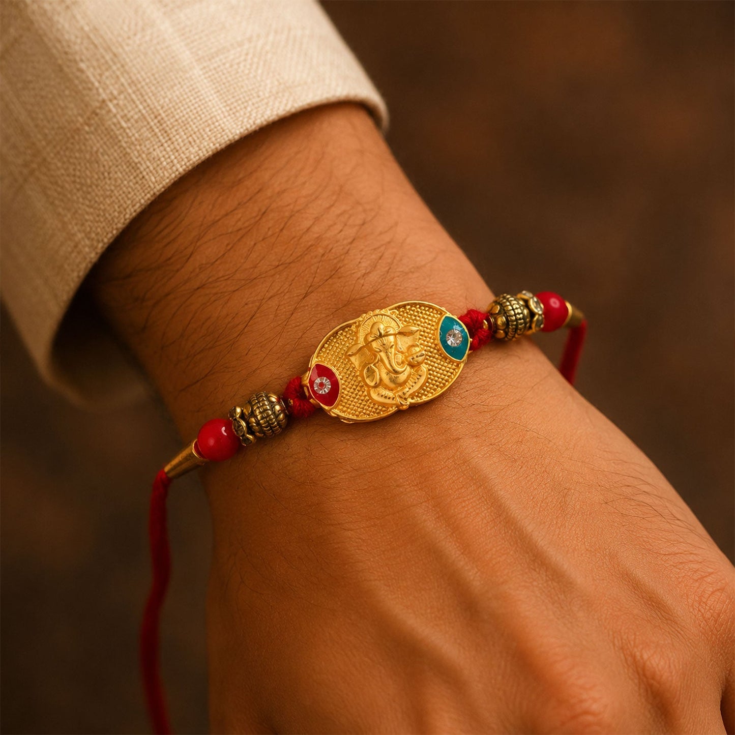 Closeup of Lord Ganesha gold-plated centerpiece in rakhi