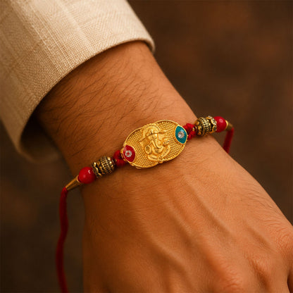 Closeup of Lord Ganesha gold-plated centerpiece in rakhi