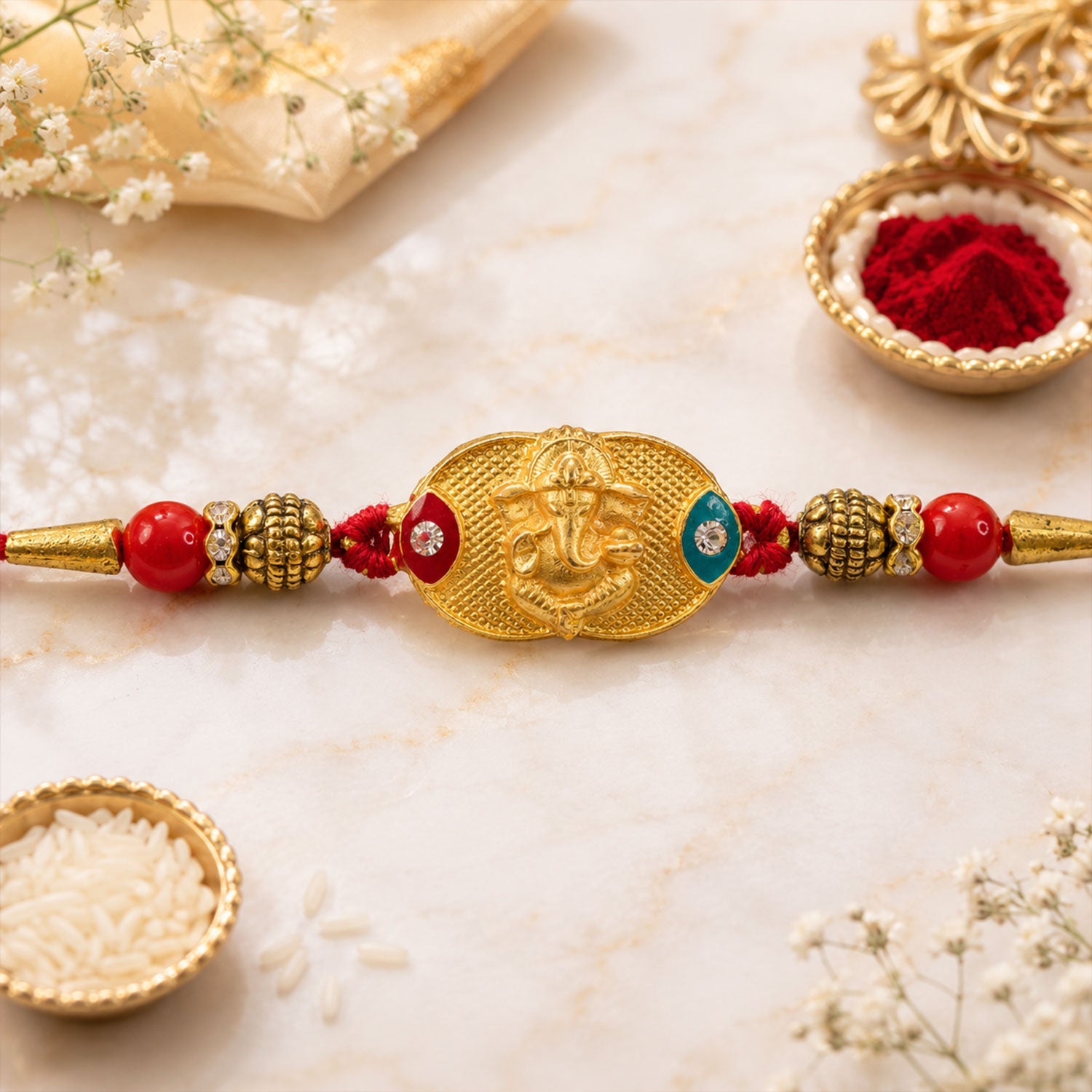 Red bead decorated rakhi thread with gold-plated pendant