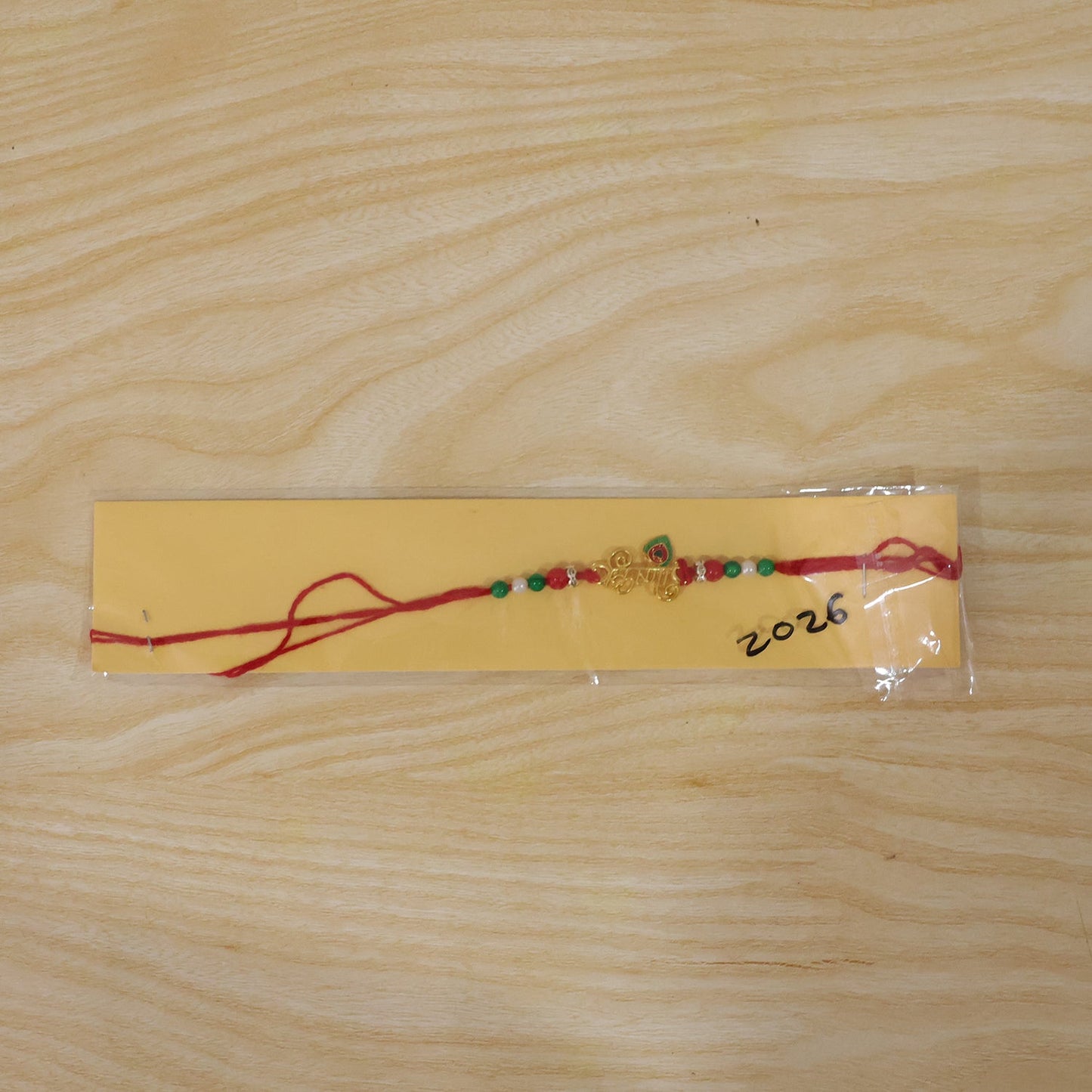Golden Krishna Text Rakhi with Beads for Brother