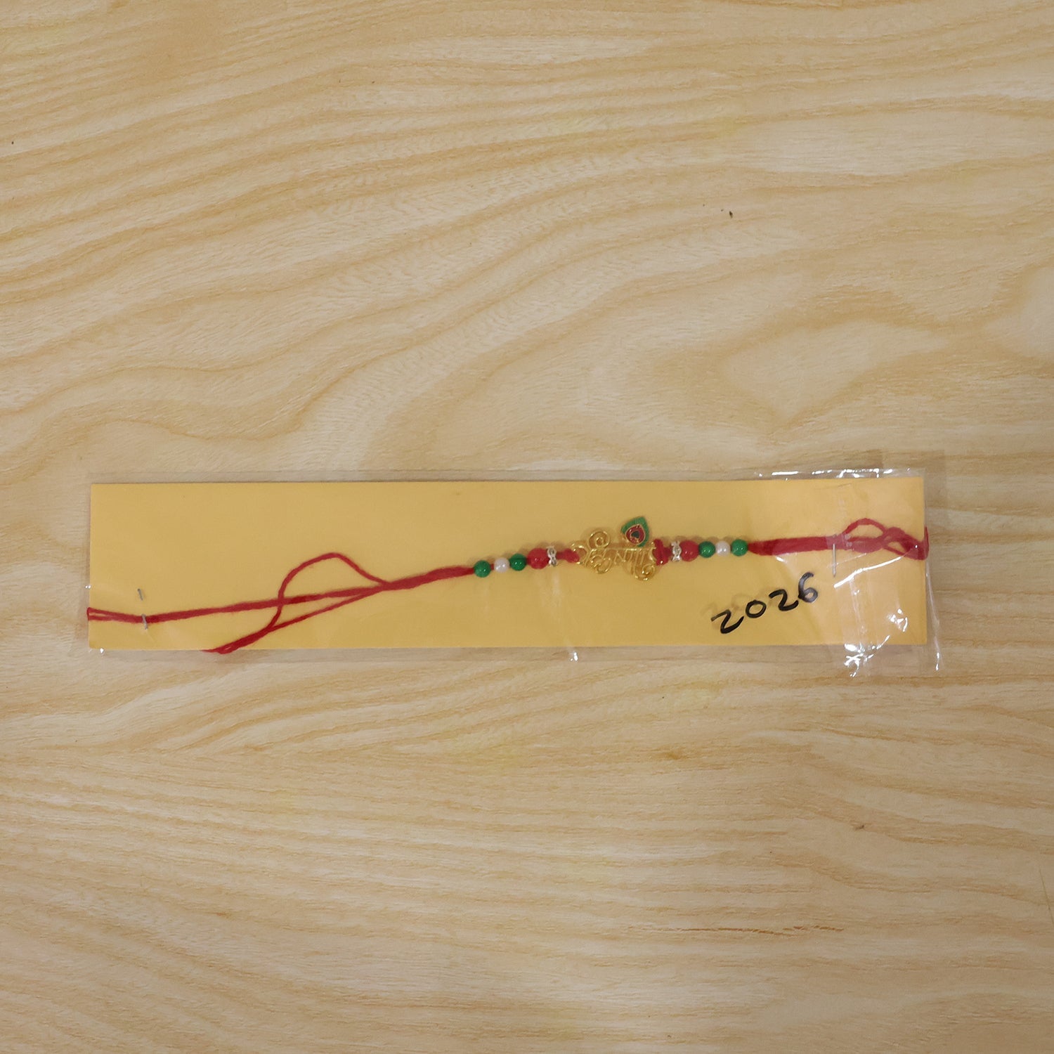 Golden Krishna Text Rakhi with Beads for Brother