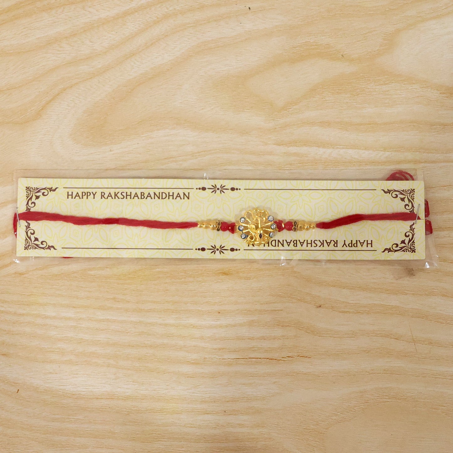 God Charm Rakhi with Blue & Red Stones for Brother - Rakshabandhan Gift