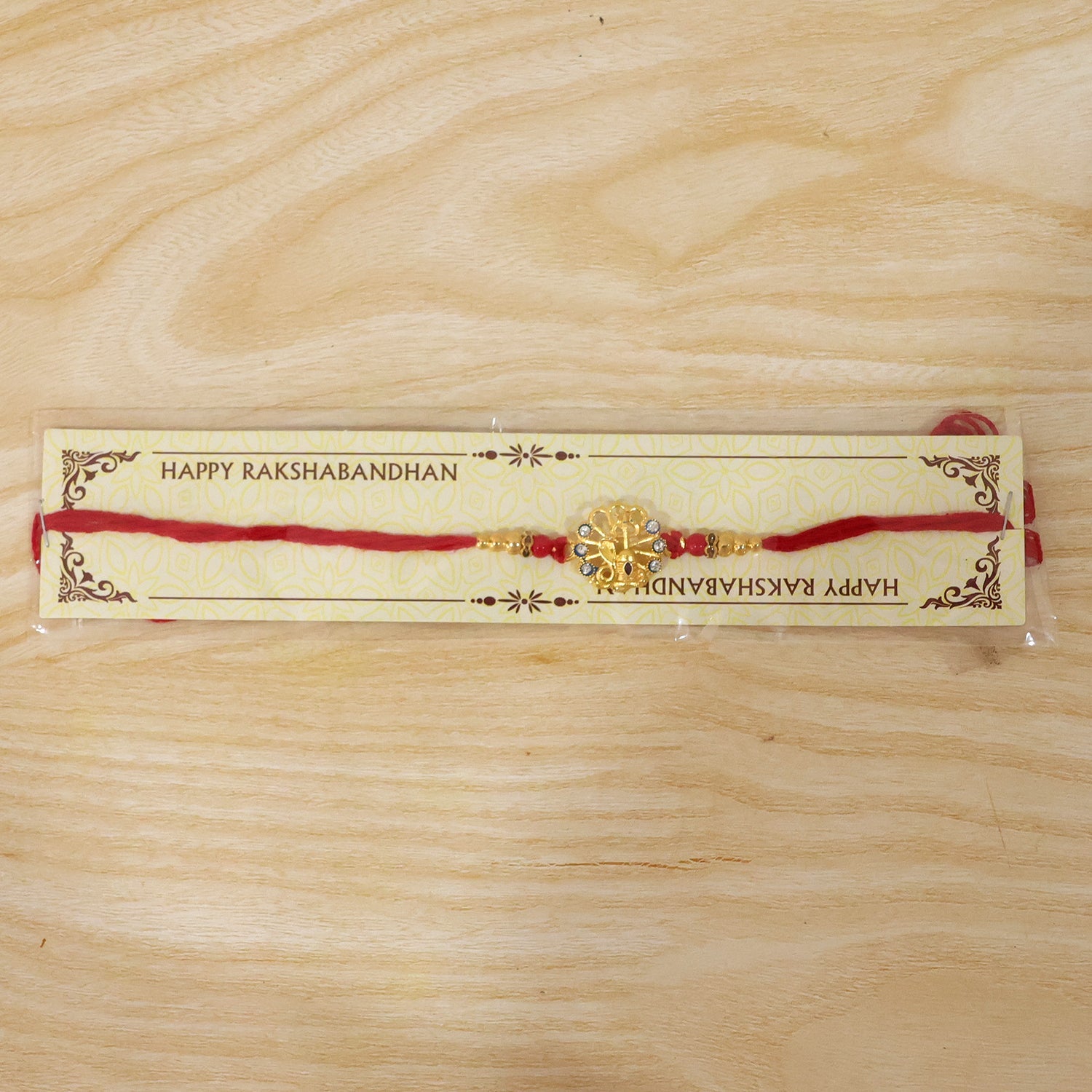 God Charm Rakhi with Blue & Red Stones for Brother - Rakshabandhan Gift