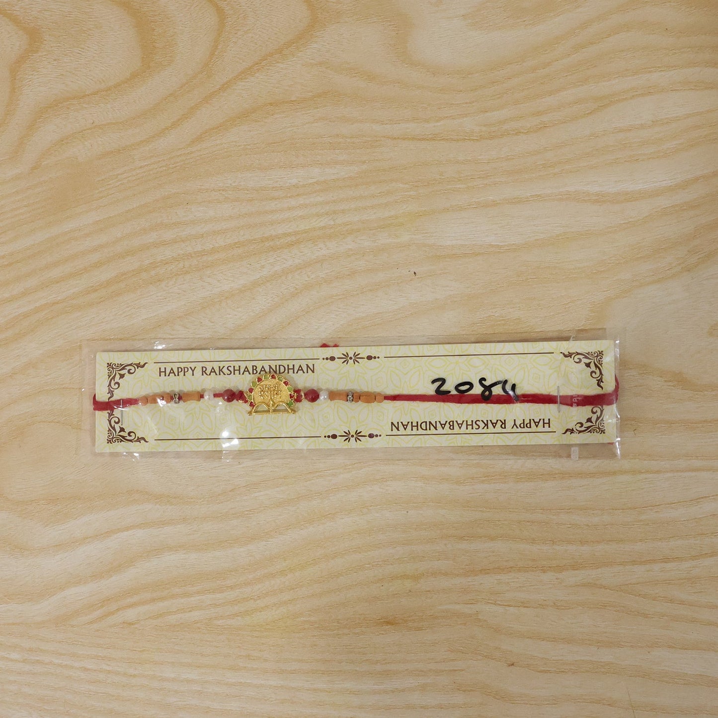 Traditional Golden Shyam Rakhi with Sandalwood Beads for Brother
