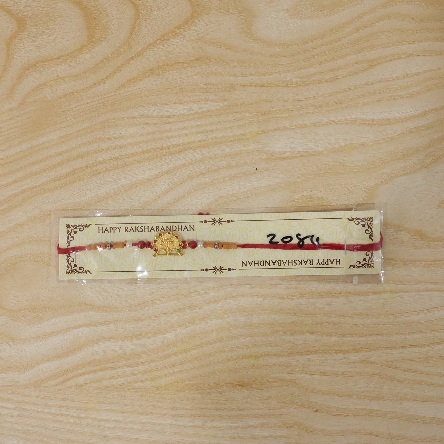 Traditional Golden Shyam Rakhi with Sandalwood Beads for Brother