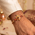 Golden Tortoise Rakhi – Auspicious OM Symbol with Stones