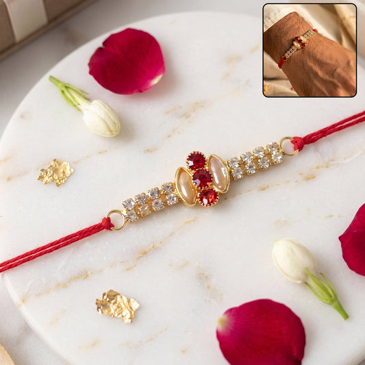 Elegant gold rakhi with pink stone & AD studded design