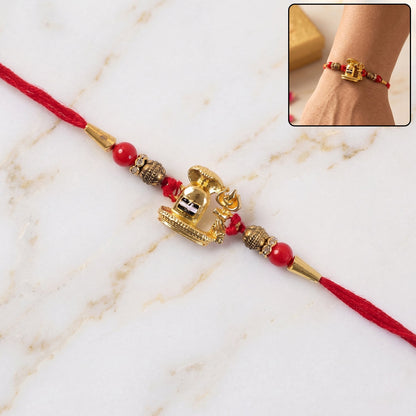 Traditional Golden Antique Shivling Motif Rakhi with Red Beads for Brother