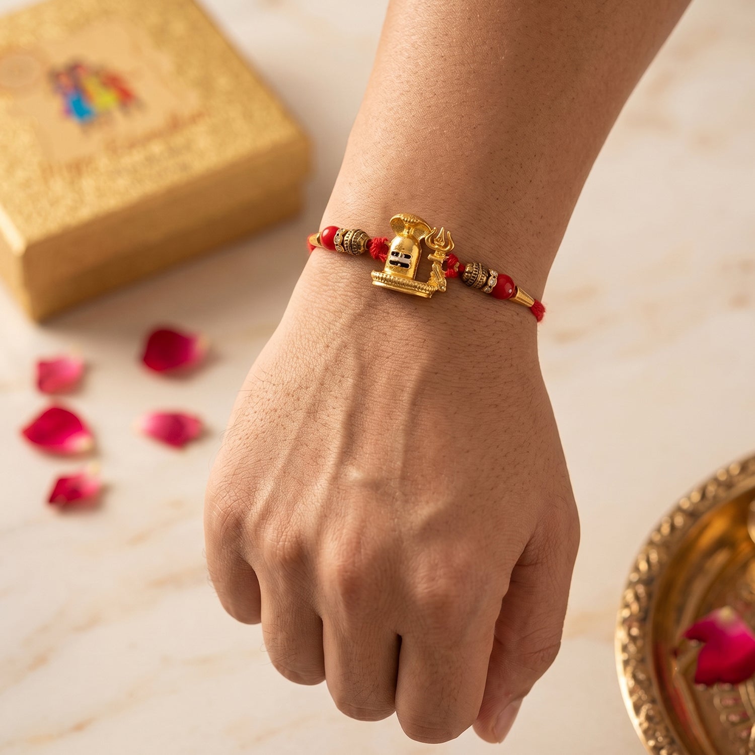 Traditional Golden Antique Shivling Motif Rakhi with Red Beads for Brother