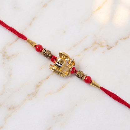 Traditional Golden Antique Shivling Motif Rakhi with Red Beads for Brother