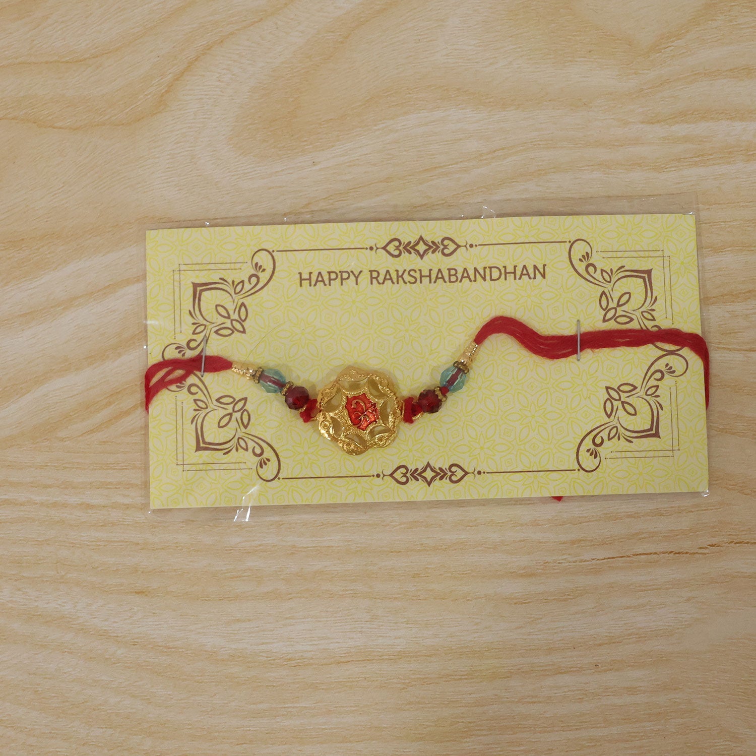 Golden Floral Rakhi with Red Stone & Crystal Beads for Brother