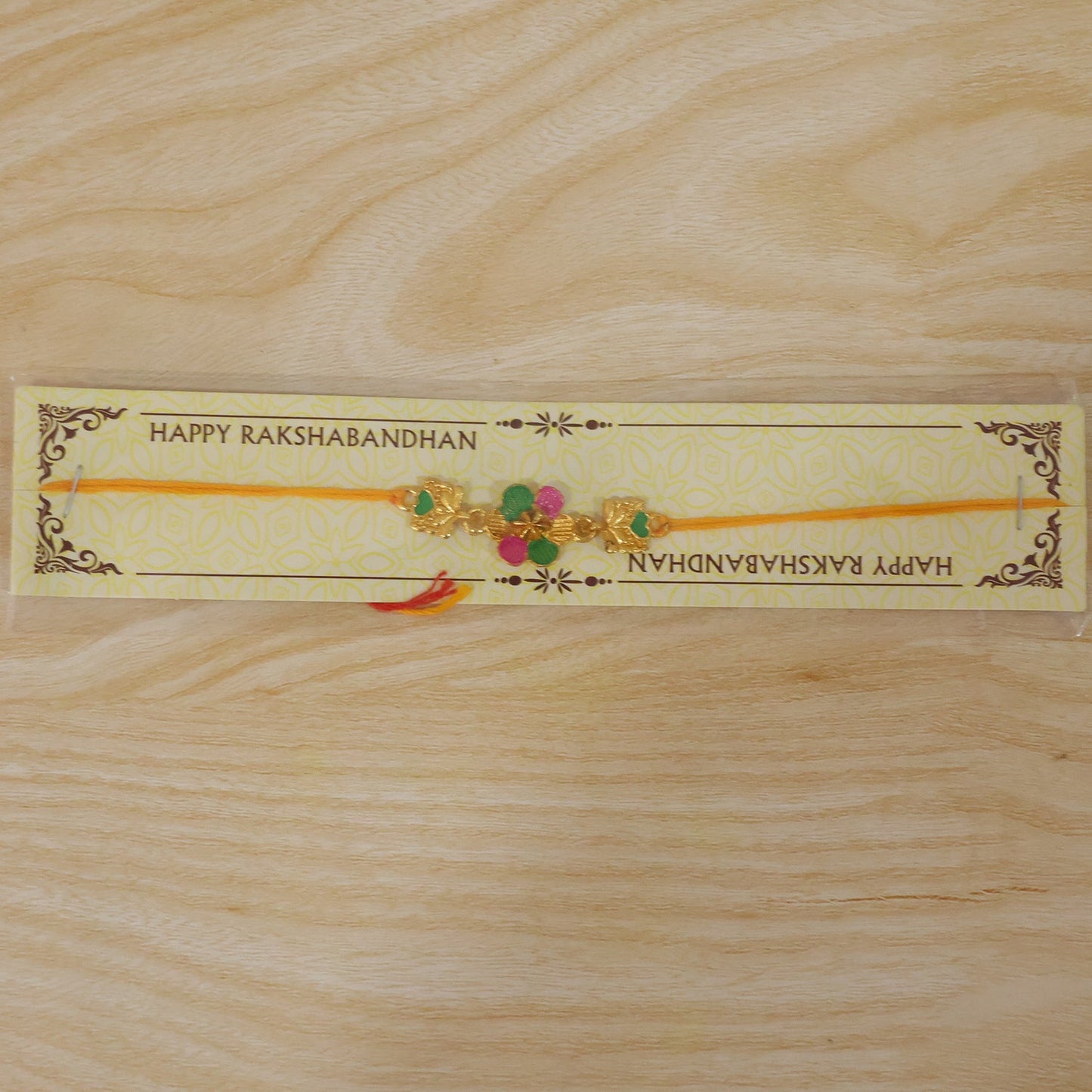 Golden Meenakari Flower Rakhi with Leaf Design for Brother