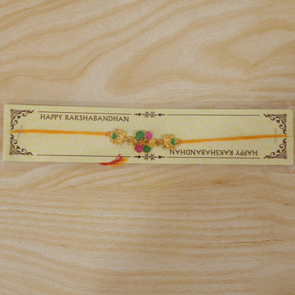 Golden Meenakari Flower Rakhi with Leaf Design for Brother