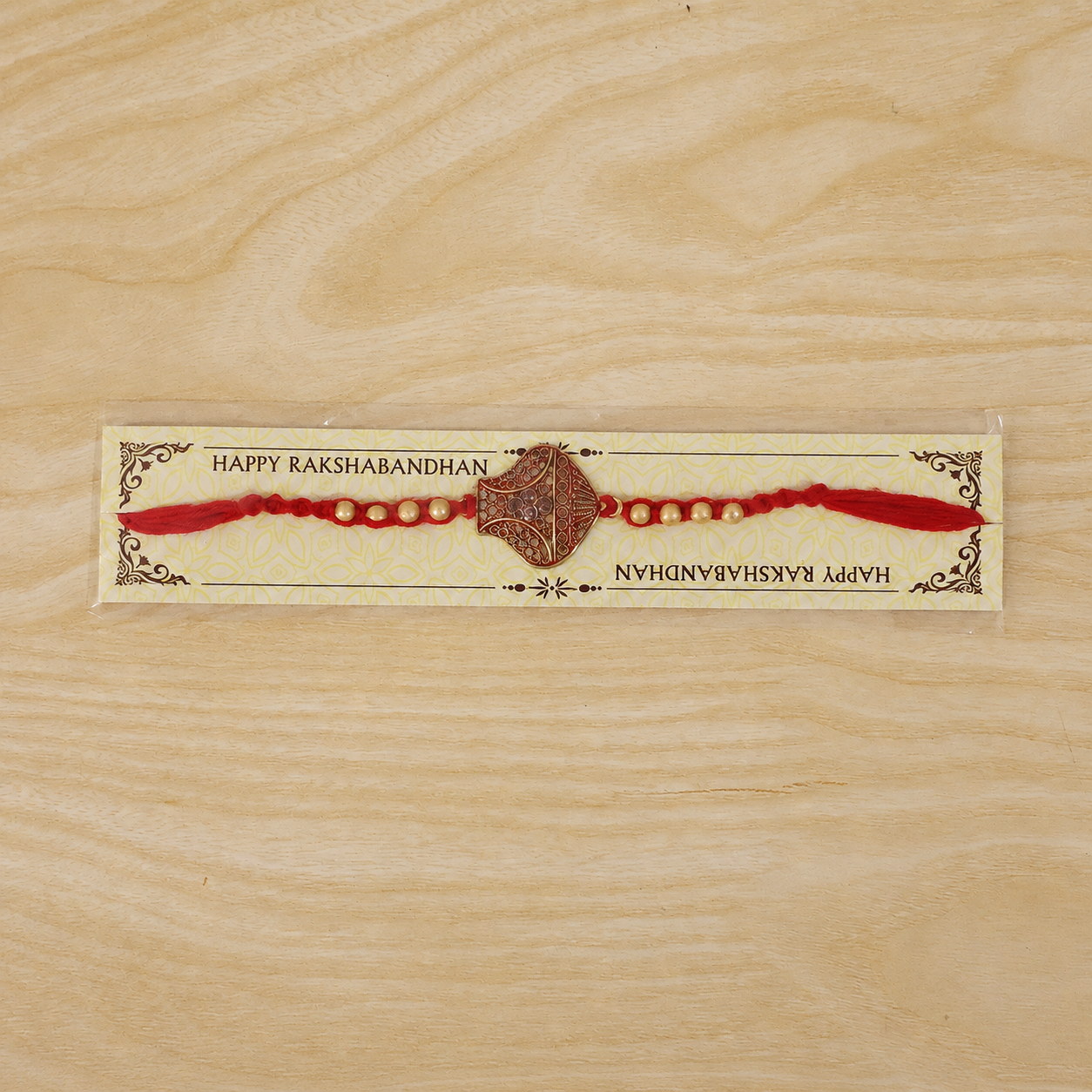 Antique Leaf-Shaped Jali Rakhi with Golden Beads for Brother