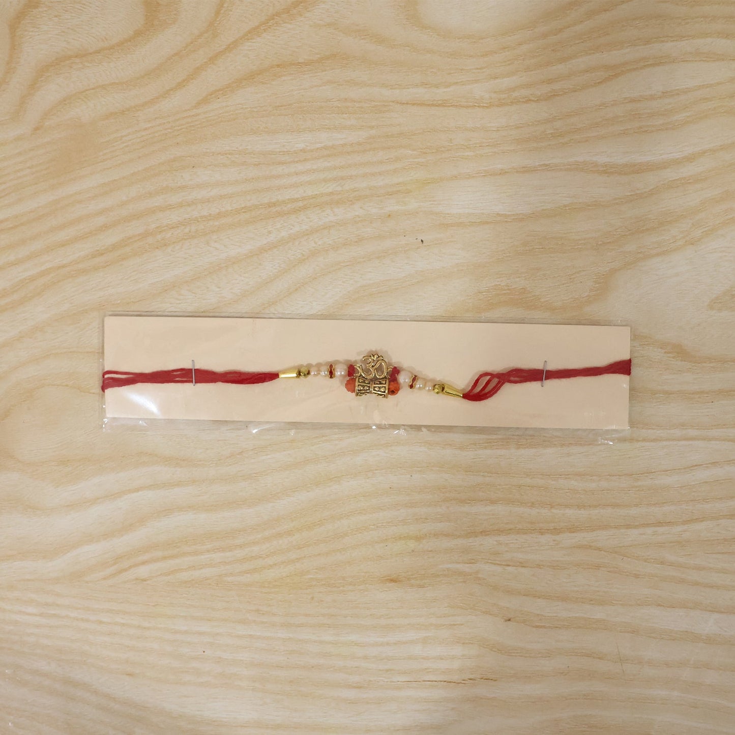Traditional Golden Om Rakhi with Rudraksha & Pearls for Brother