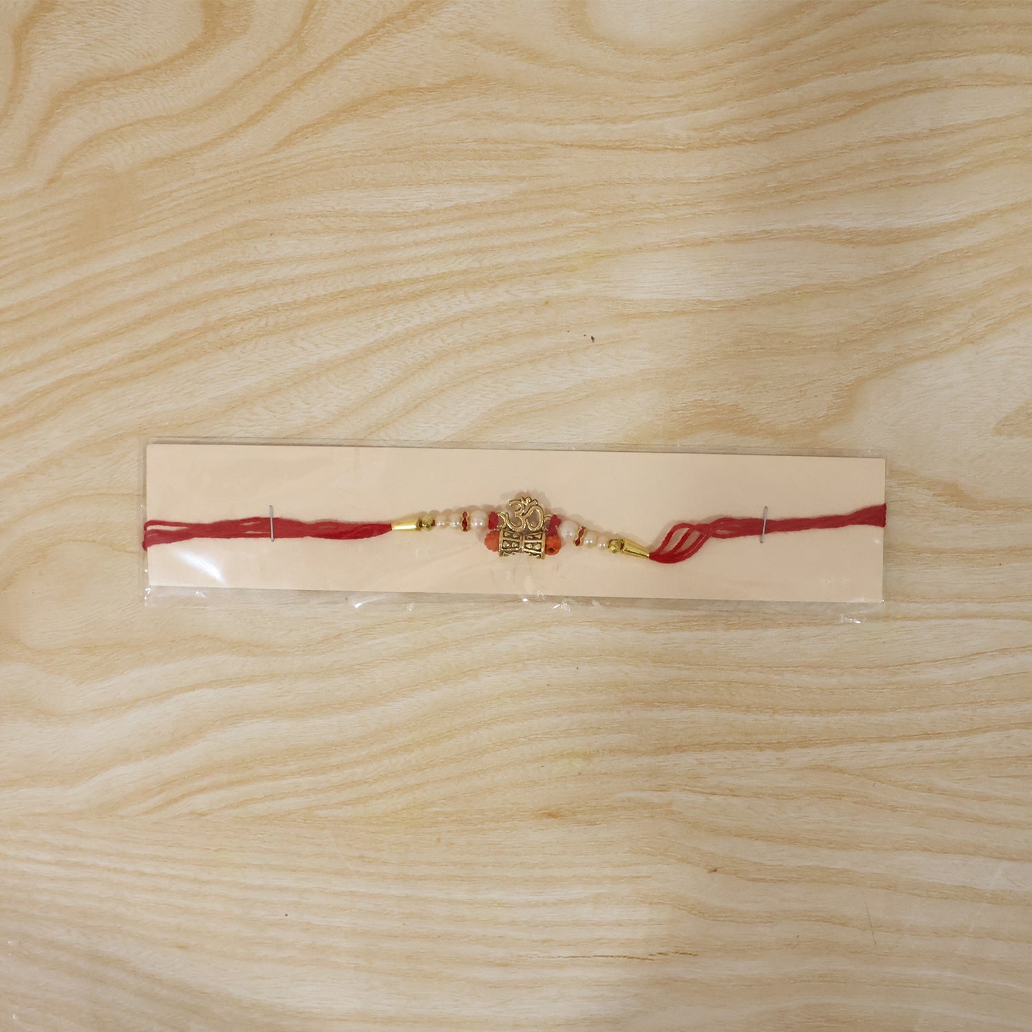Traditional Golden Om Rakhi with Rudraksha & Pearls for Brother