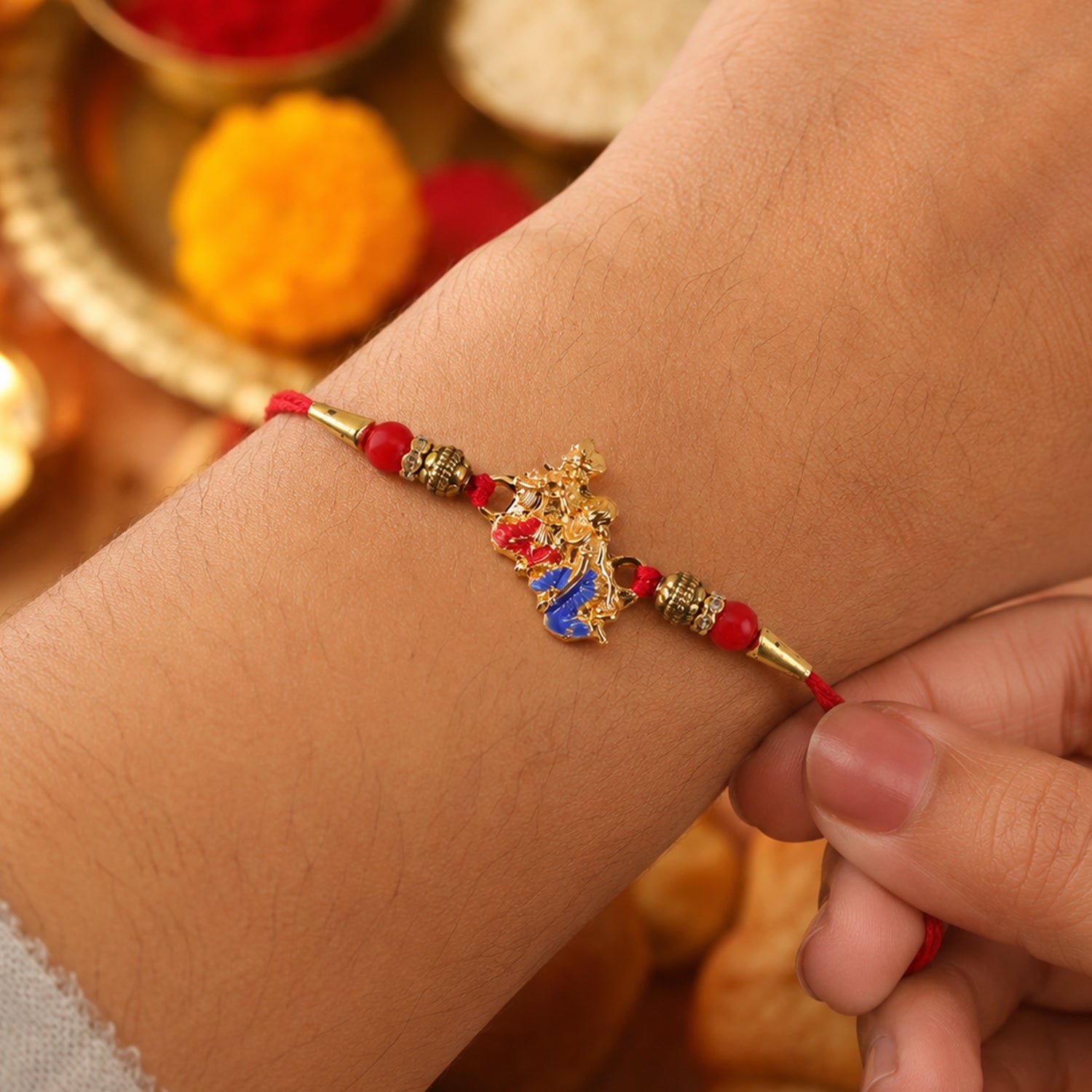 Golden Peacock (Mor) Rakhi with Blue Enamel & Red Beads