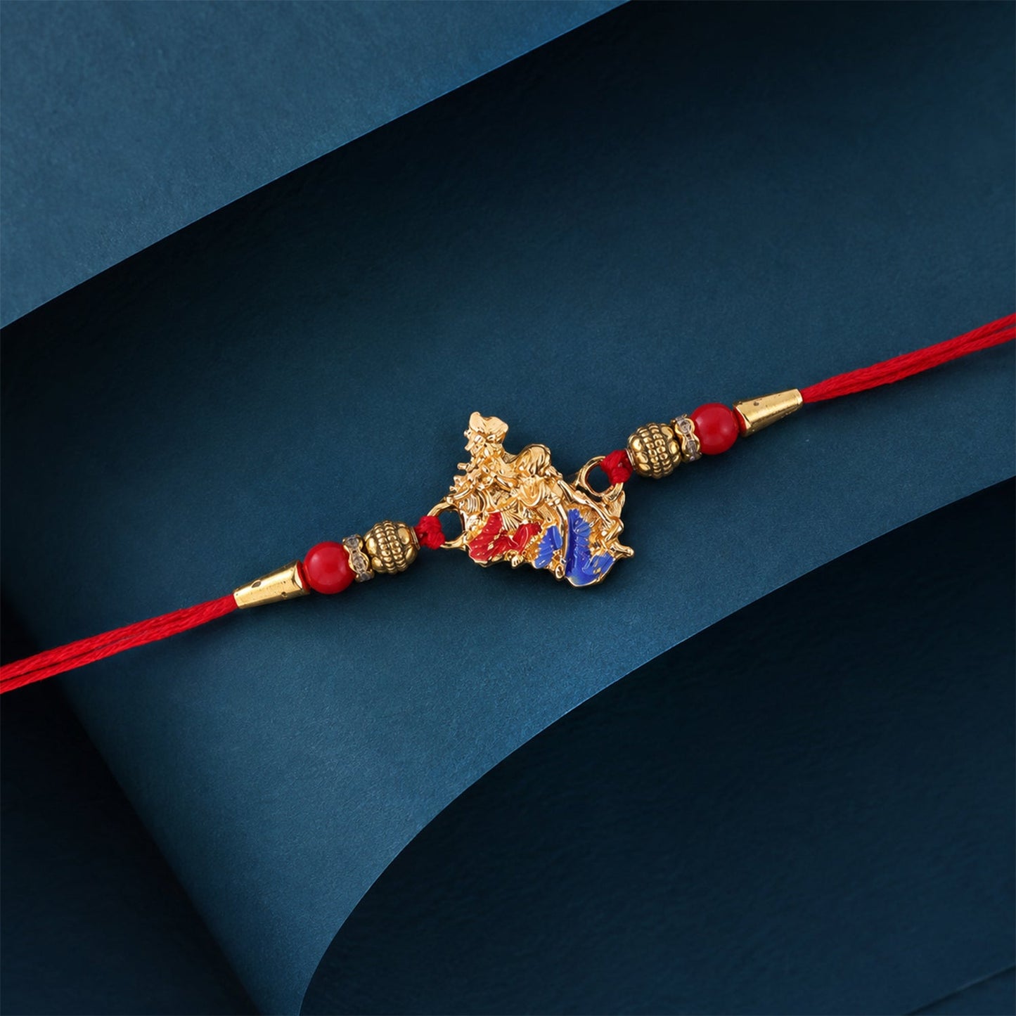 Golden Peacock (Mor) Rakhi with Blue Enamel & Red Beads