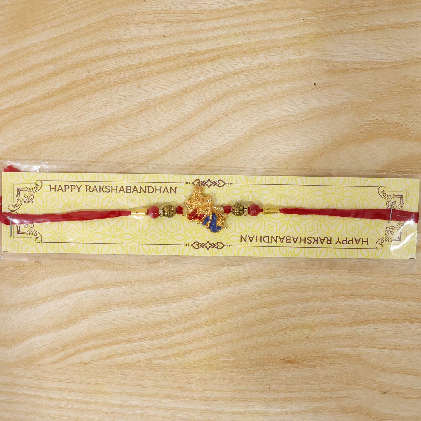 Golden Peacock (Mor) Rakhi with Blue Enamel & Red Beads