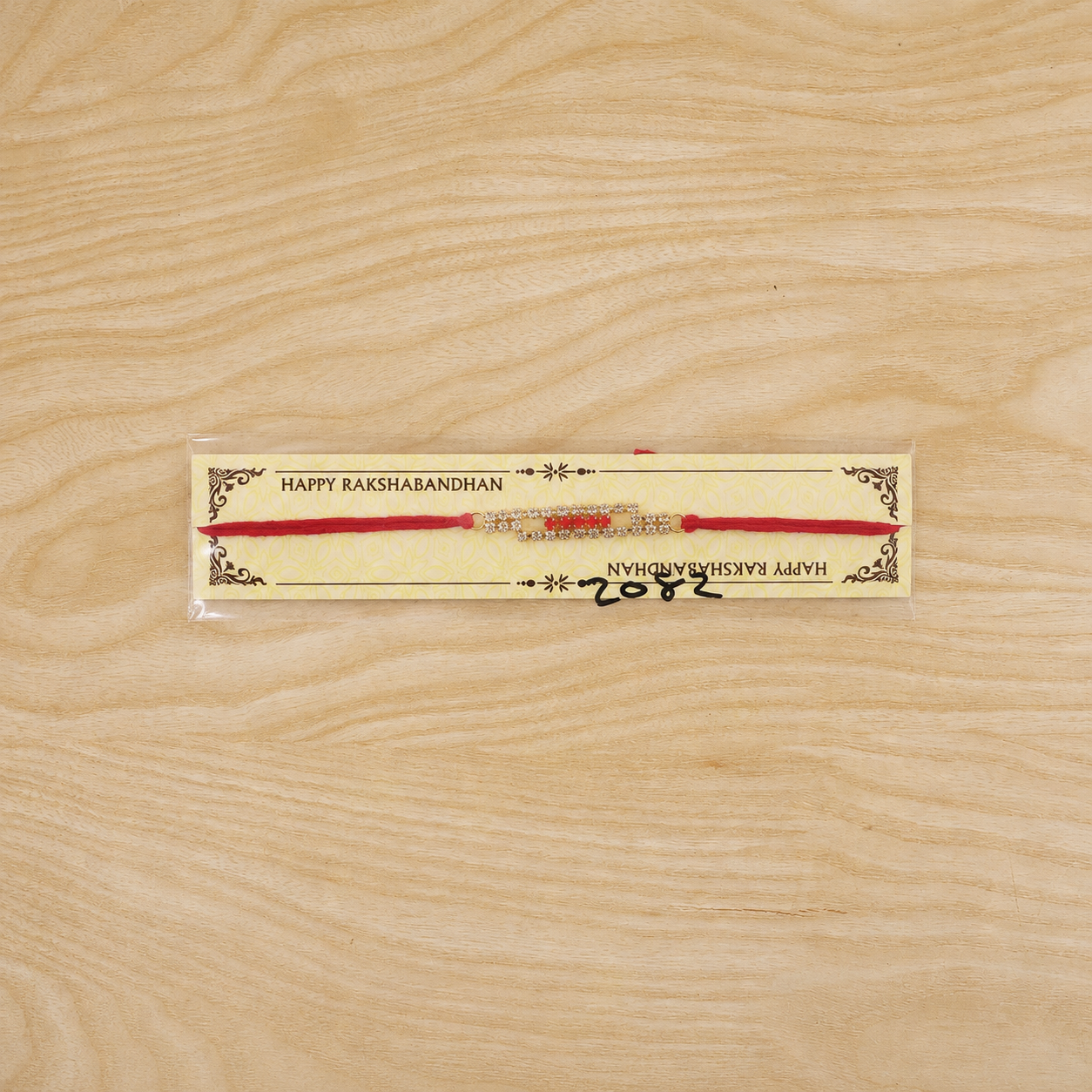 Slim American Diamond Studded Bar Rakhi on Red Thread