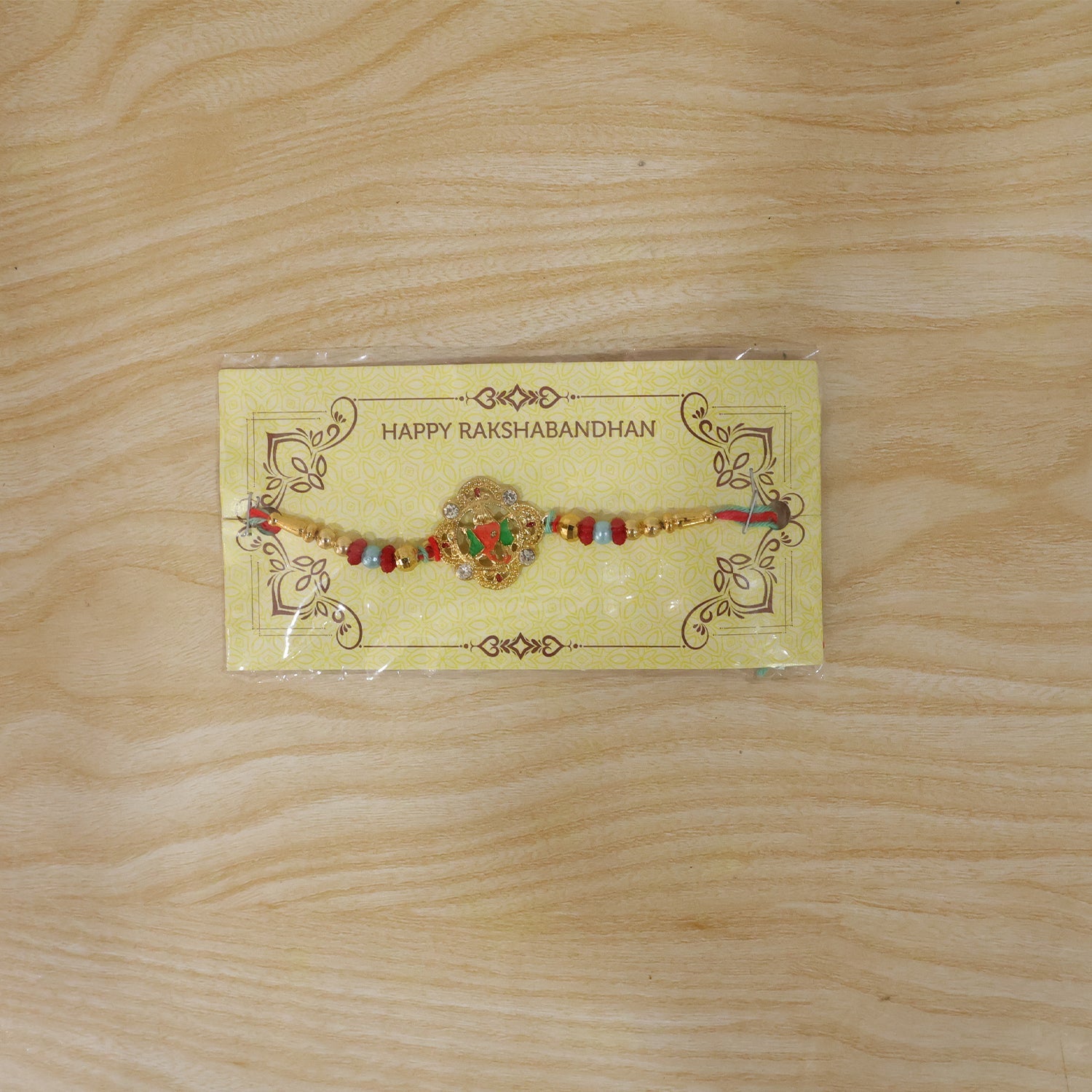 Colourful Floral Kundan Rakhi with Green Peacock Accent