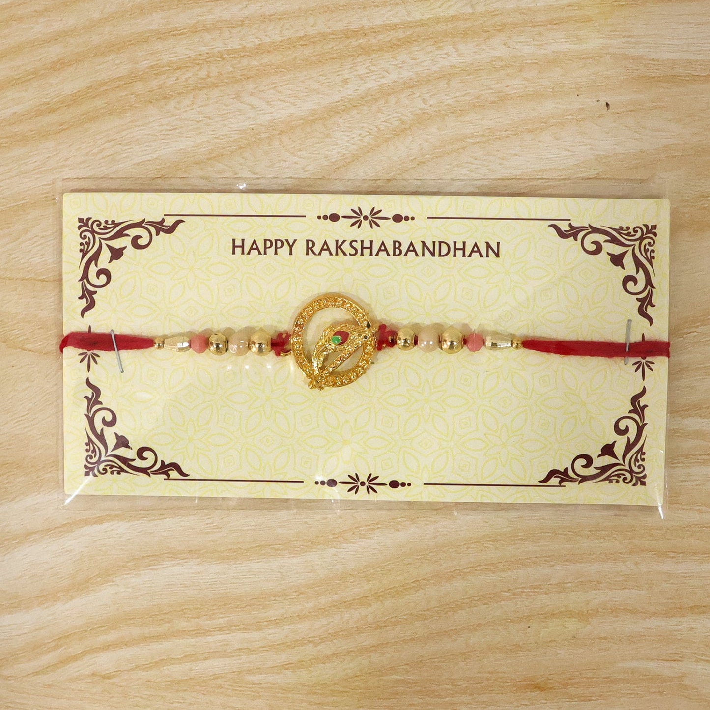 Golden Peacock Spiral Rakhi with Beads